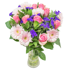 Guided by years of experience in Rotherhithe's vibrant floral scene, I arrange this bouquet with a craftsman's touch-pairing the gentle blush of gerberas alongside perfectly formed pink roses that evoke Riverside's signature romantic charm. The petals, layered like soft watercolor brushstrokes, embody freshness and subtle luxury, while sprigs of deep purple statice weave through the arrangement adding pockets of visual excitement. Dewy emerald leaves anchor the bouquet, echoing the tranquil parklands and greenways that weave through the heart of Rotherhithe. Resting in a sleek glass vase, each flower finds its place in a delicate ballet of texture and colour, their gentle scents filling the air with a taste of spring mornings and neighborhood optimism. This composition glows tenderly in natural daylight, its palette harmonising yet full of energetic promise-perfect as a thoughtful get-well gesture or as a luminous accent on a family table along Brunel Road. From first selection at the market stalls to the final ribbon, the design is imbued with neighbourly care and an eye for meaningful detail. Whether surprising loved ones for birthdays or sending comfort across the community, every facet of this bouquet testifies to the artistry and heart at the centre of local floristry in Rotherhithe.